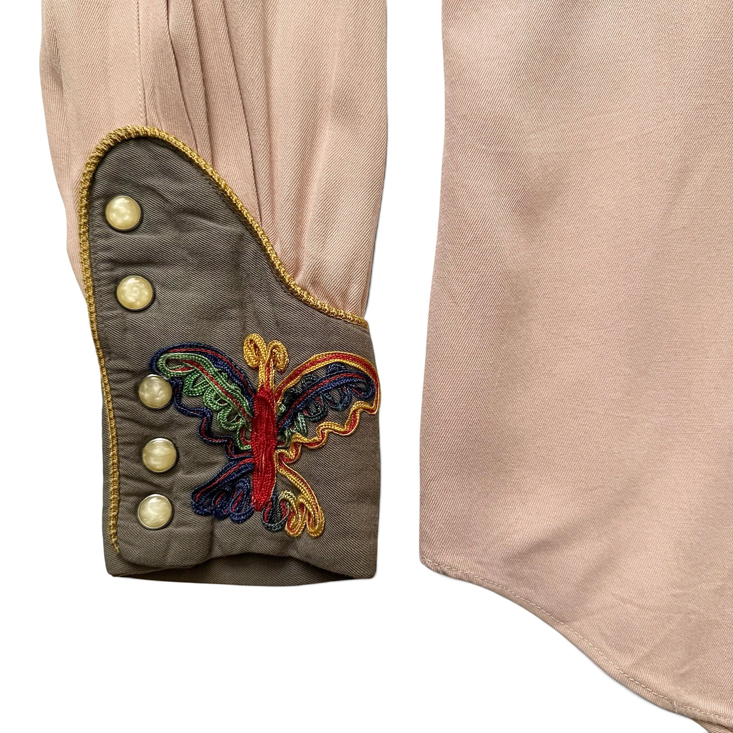 1940/1950s Las Vegas By Cowboy Joe Embroidered Western Shirt Close-up of a garment with embroidered butterfly design and buttons on a beige background