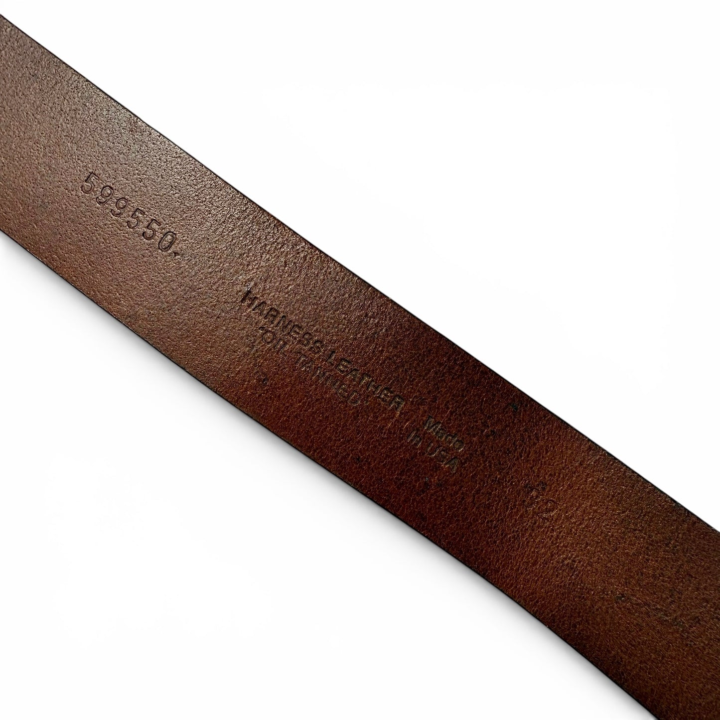 1970 Enamel And Brass "Clean Air Land Water" Buckle Leather Belt Close-up of a brown leather belt with visible branding on a white background