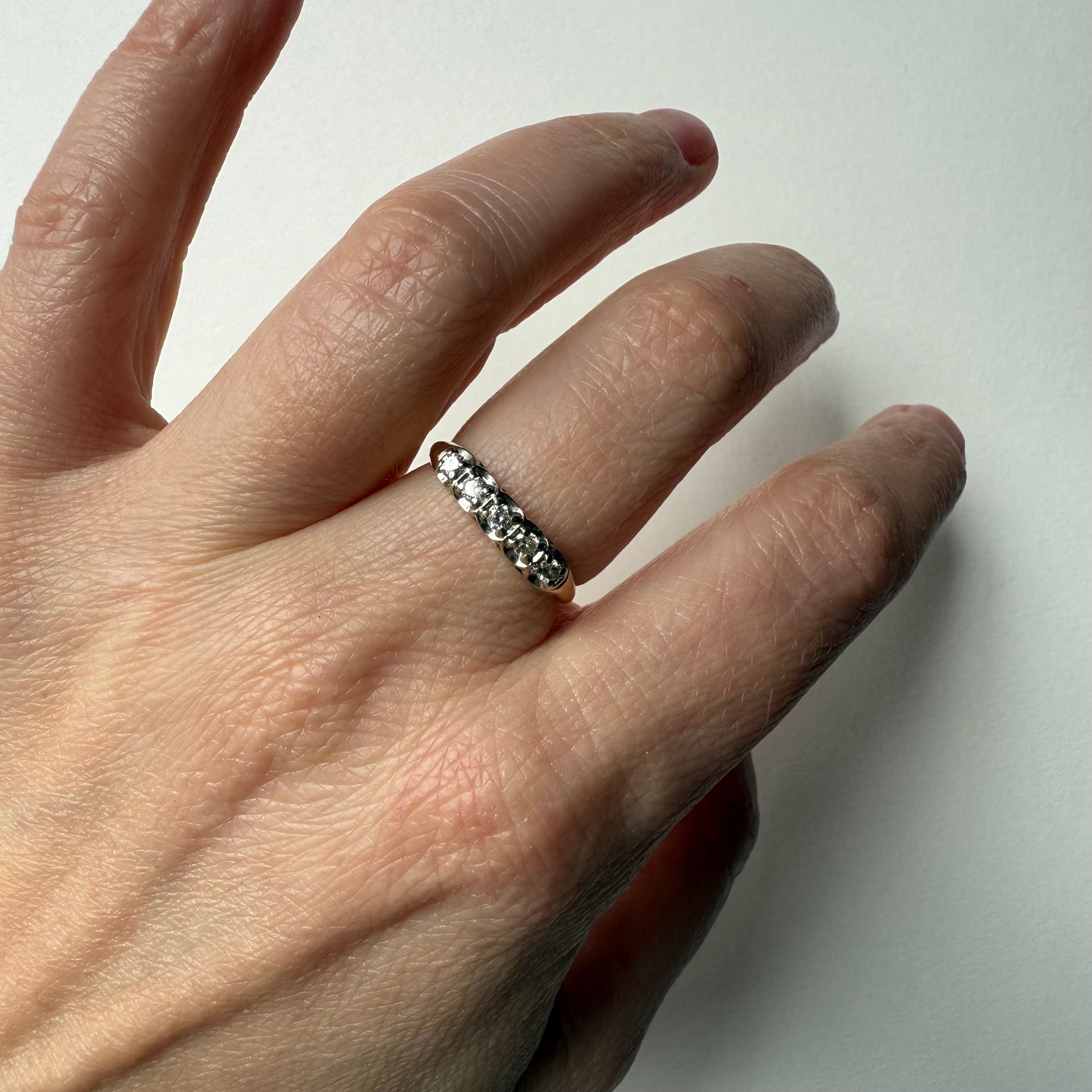 14K Yellow Gold .25ctw 5 Diamond Band Ring on hand