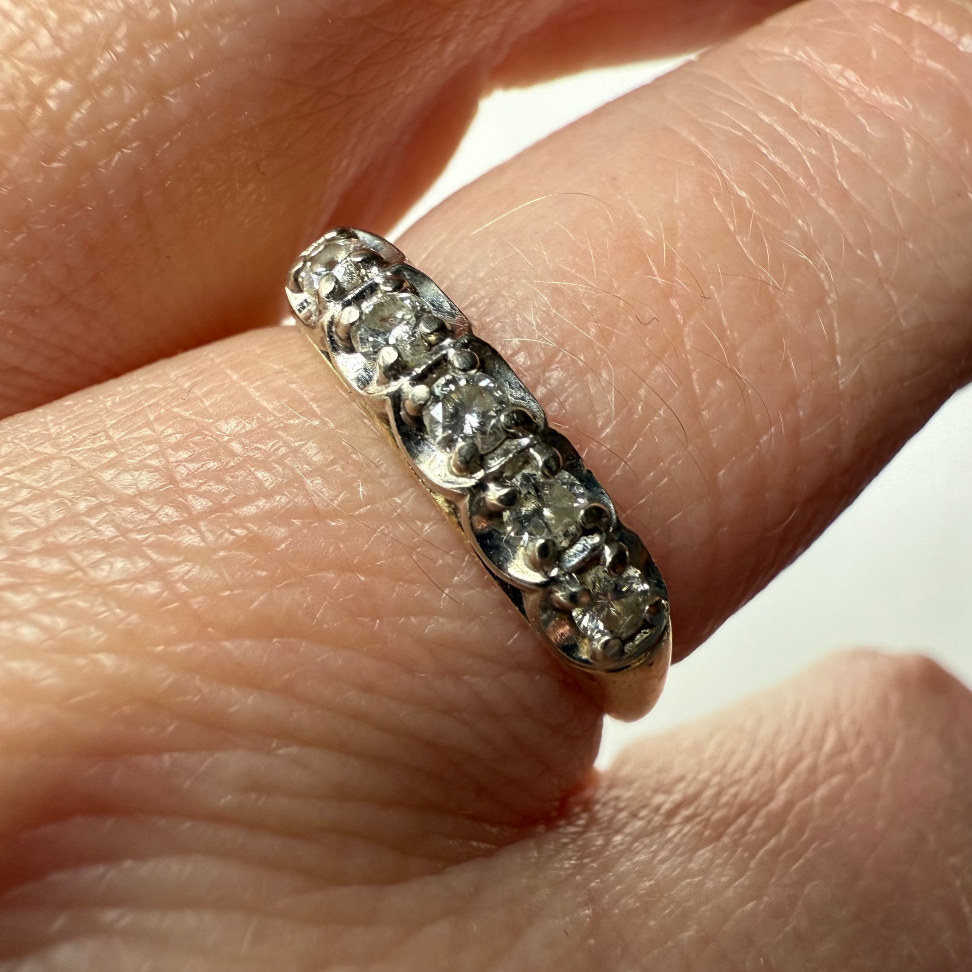 close-up of 14K Yellow Gold .25ctw 5 Diamond Band Ring on hand
