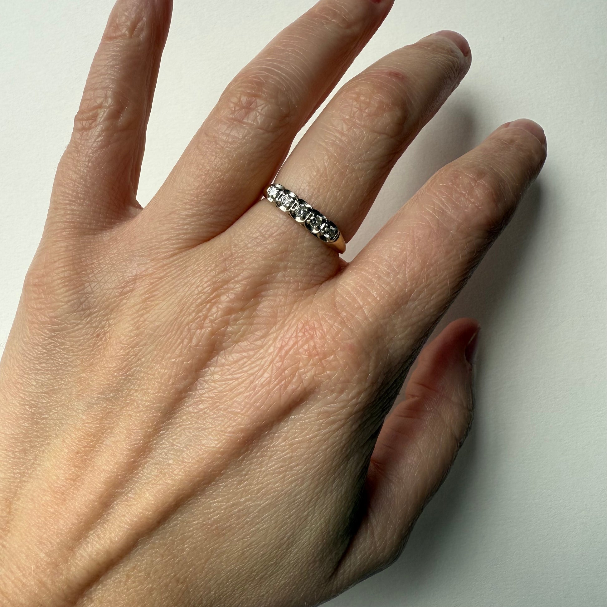 14K Yellow Gold .25ctw 5 Diamond Band Ring on hand