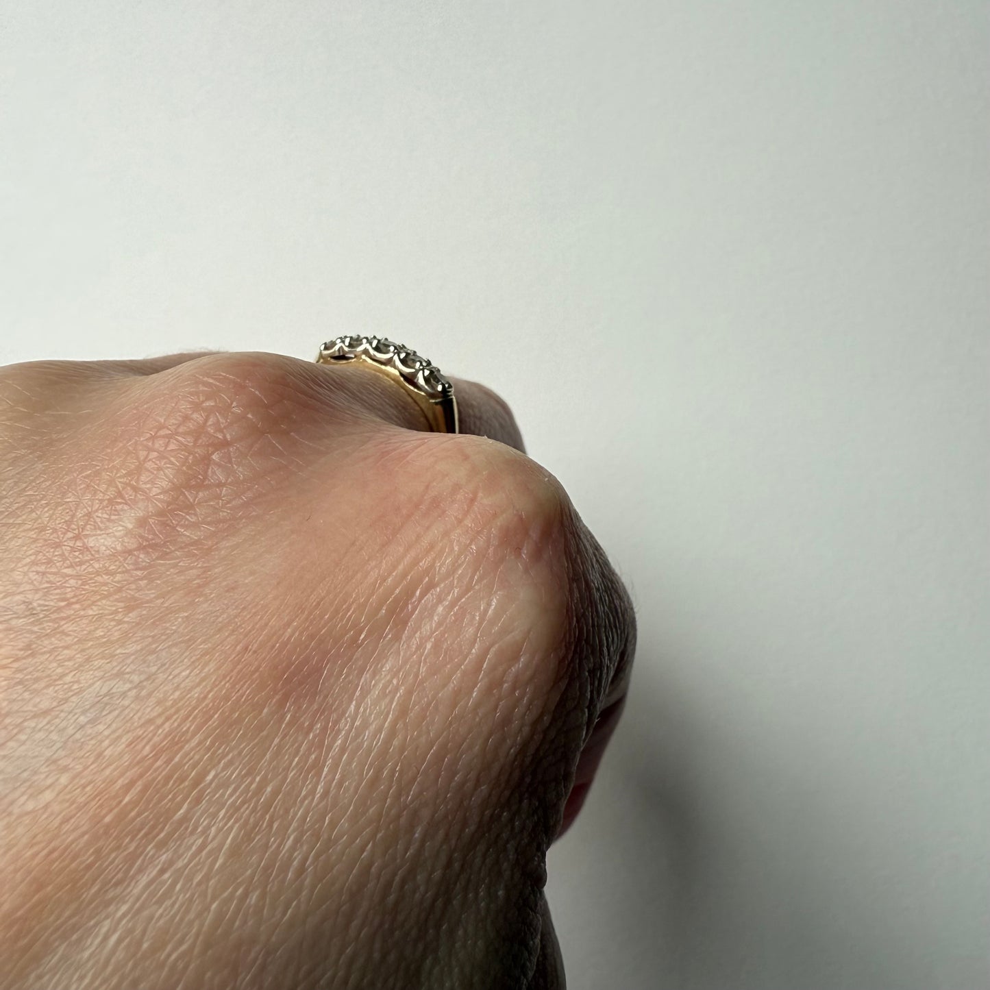 14K Yellow Gold .25ctw 5 Diamond Band Ring on hand side view
