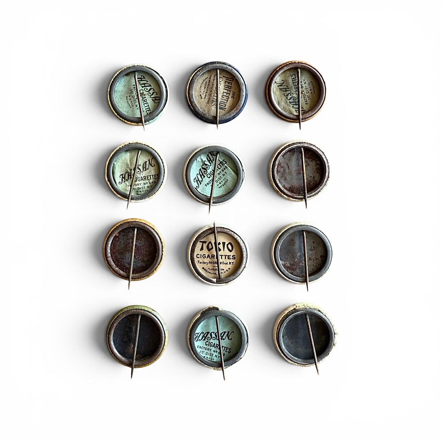Collection of vintage cigarette pack caps on a white background