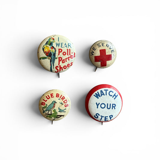 1930-1940s Pinbacks Four vintage buttons with different designs on a white background
