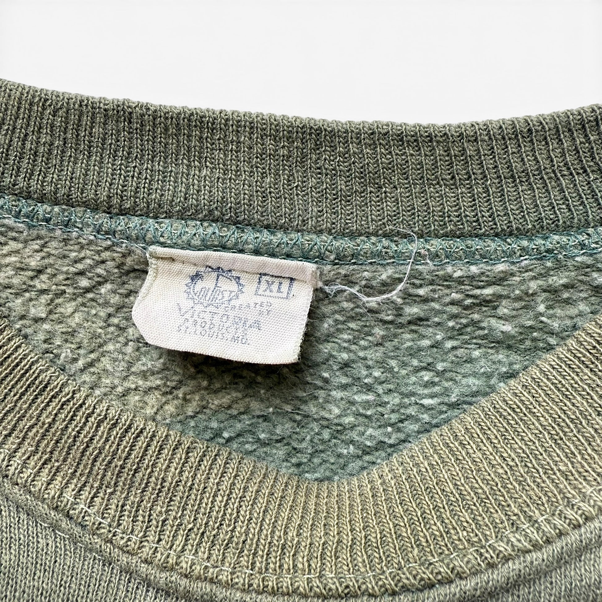 1950/1960s Camp Widjwagan (YMCA) Short Sleeve Sweatshirt Close-up of a green sweater with a label on a white background