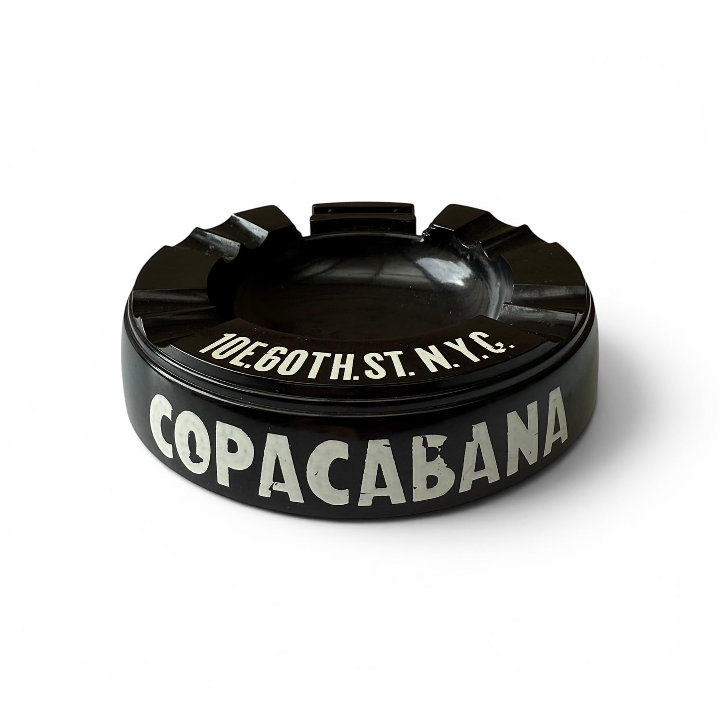 1950s Copacabana Bakelite Ashtray Black ashtray with 'Copacabana' and address text on a white background