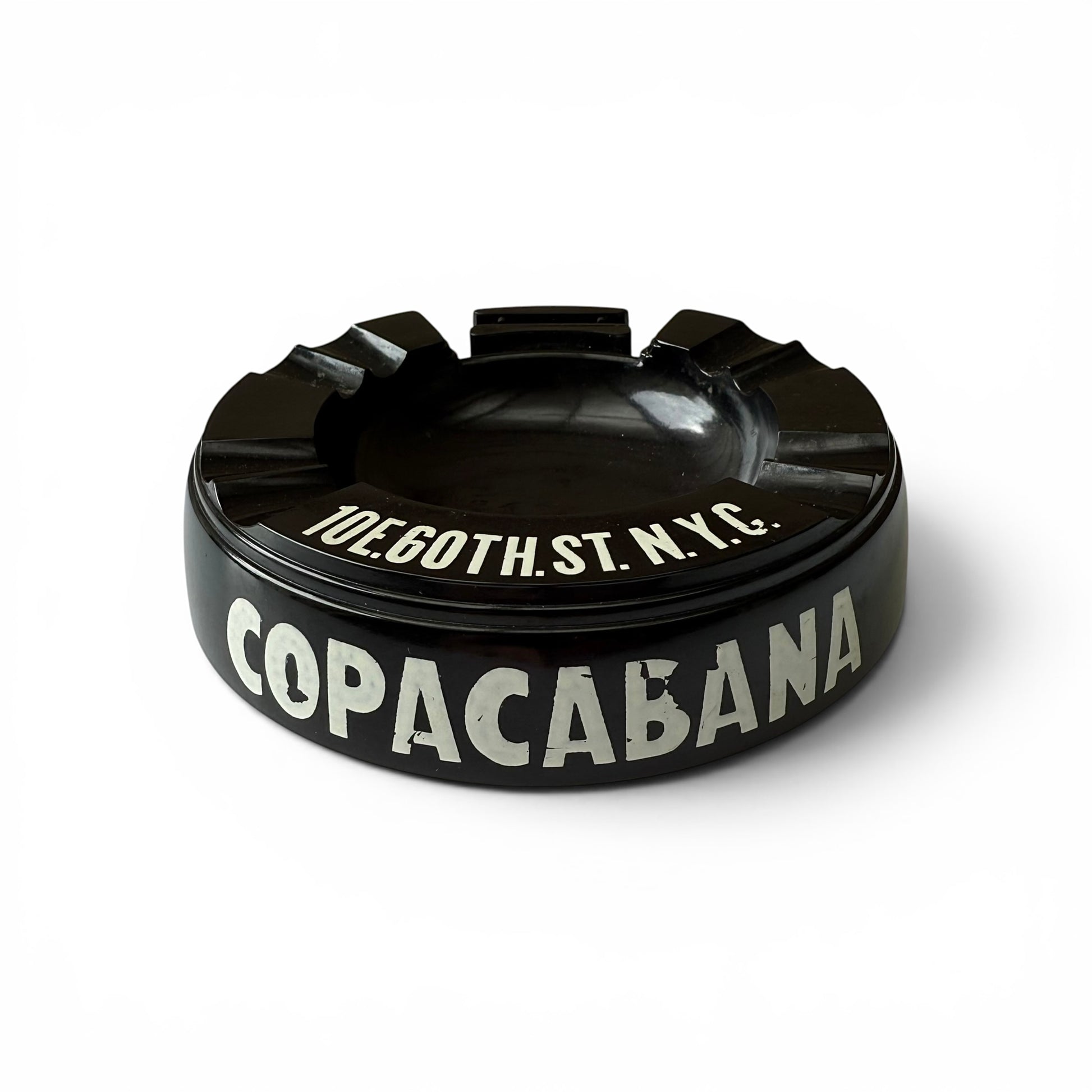 1950s Copacabana Bakelite Ashtray Black ashtray with 'Copacabana' and address text on a white background