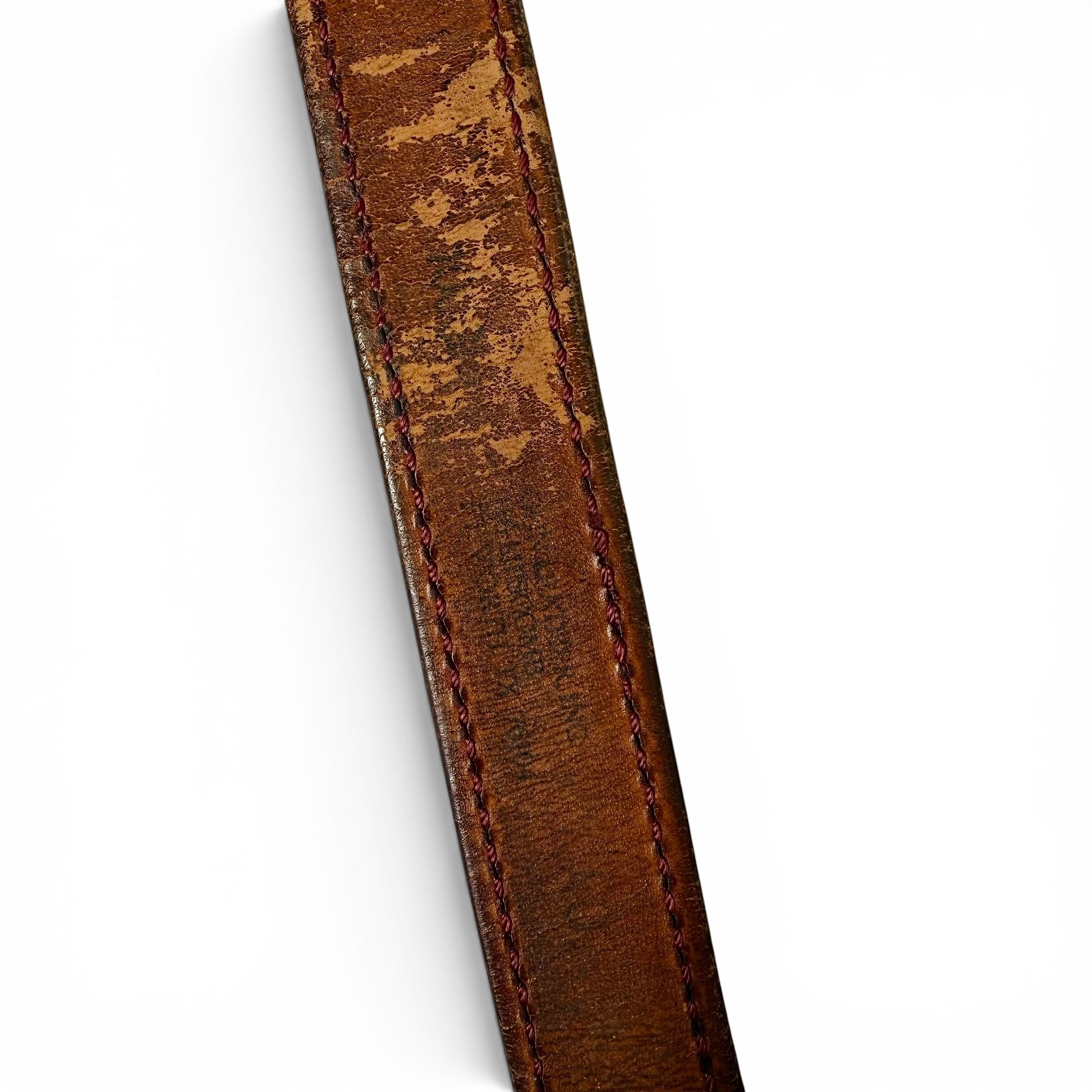 1950s Goodyear Semi Truck Brass Buckle Leather Belt Close-up of a brown leather strap with visible stitching on a white background