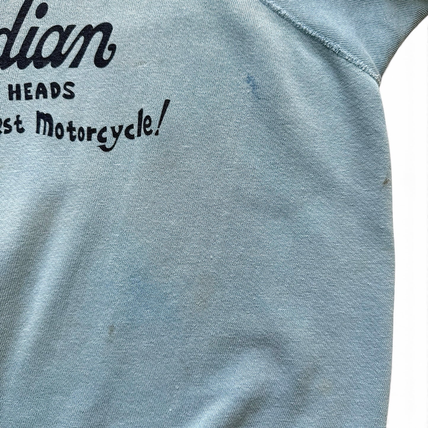1960s Indian Motorcycles Short Sleeve Sweatshirt Text on a blue fabric background, likely related to motorcycle history.