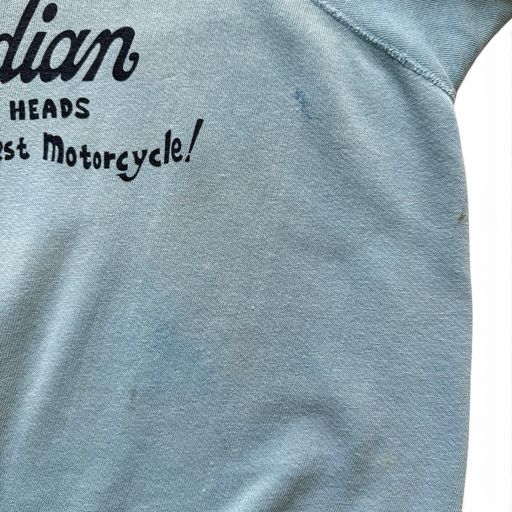 1960s Indian Motorcycles Short Sleeve Sweatshirt Text on a blue fabric background, likely related to motorcycle history.