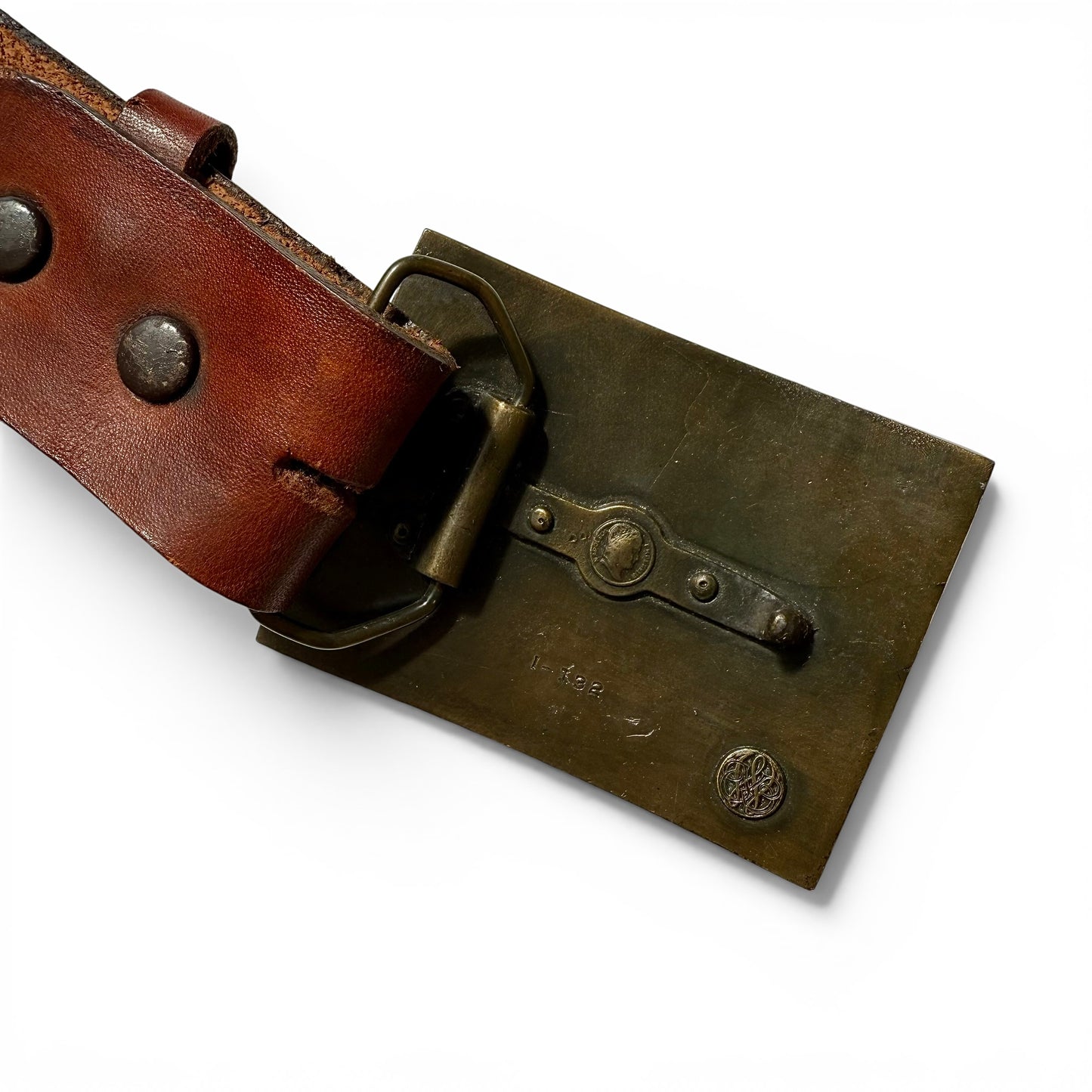 1970s Brass Eagle Buckle On Tooled Leather Brown leather belt with brass buckle on a white background