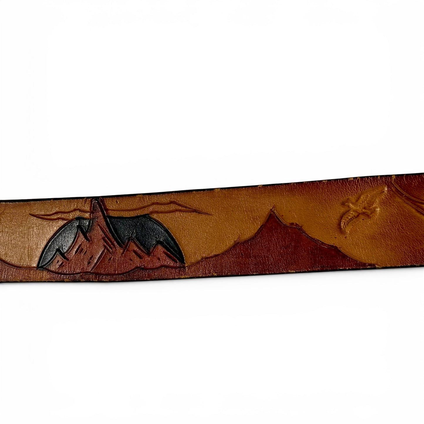 1970s Brass Eagle In Sunburst Tooled Leather Belt Leather belt with mountain and tent design on a white background