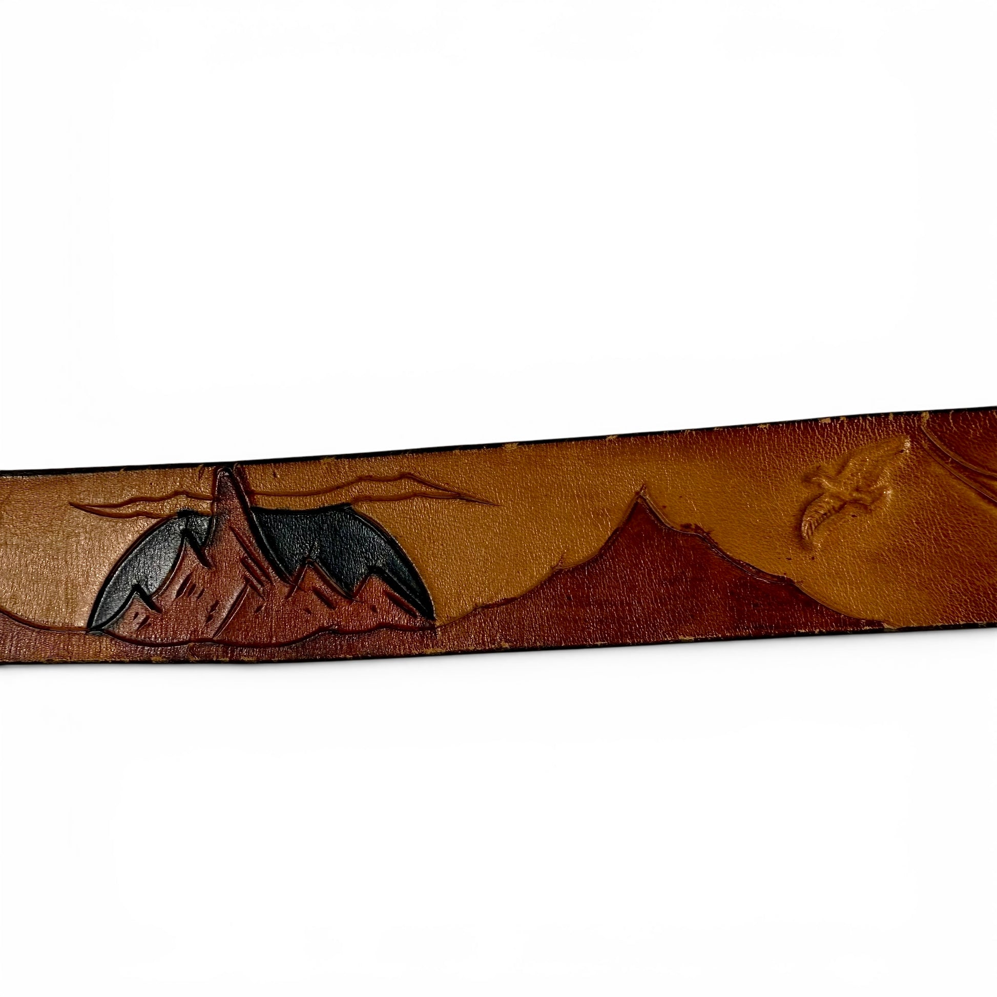 1970s Brass Eagle In Sunburst Tooled Leather Belt Leather belt with mountain and tent design on a white background