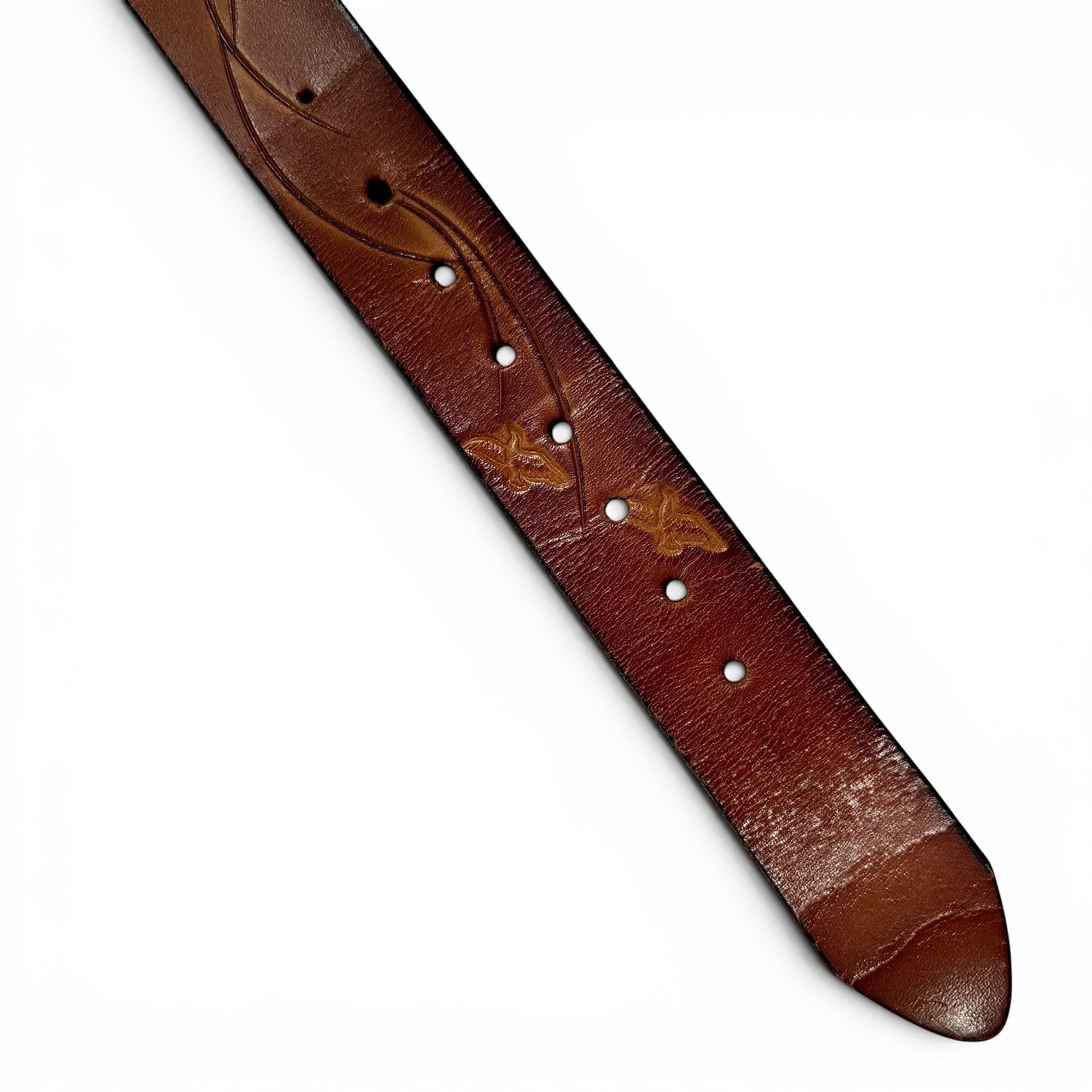 1970s Brass Eagle In Sunburst Tooled Leather Belt Brown leather guitar strap with decorative stitching on a white background