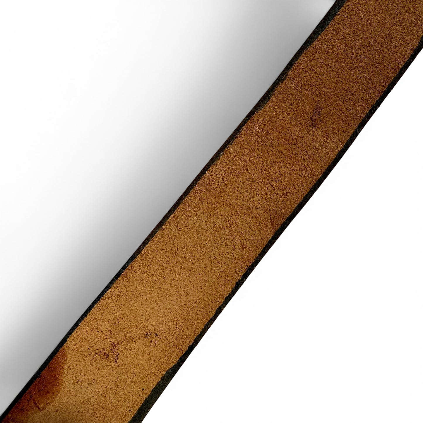 1970s Brass Eagle In Sunburst Tooled Leather Belt Close-up of a brown leather strap on a white background