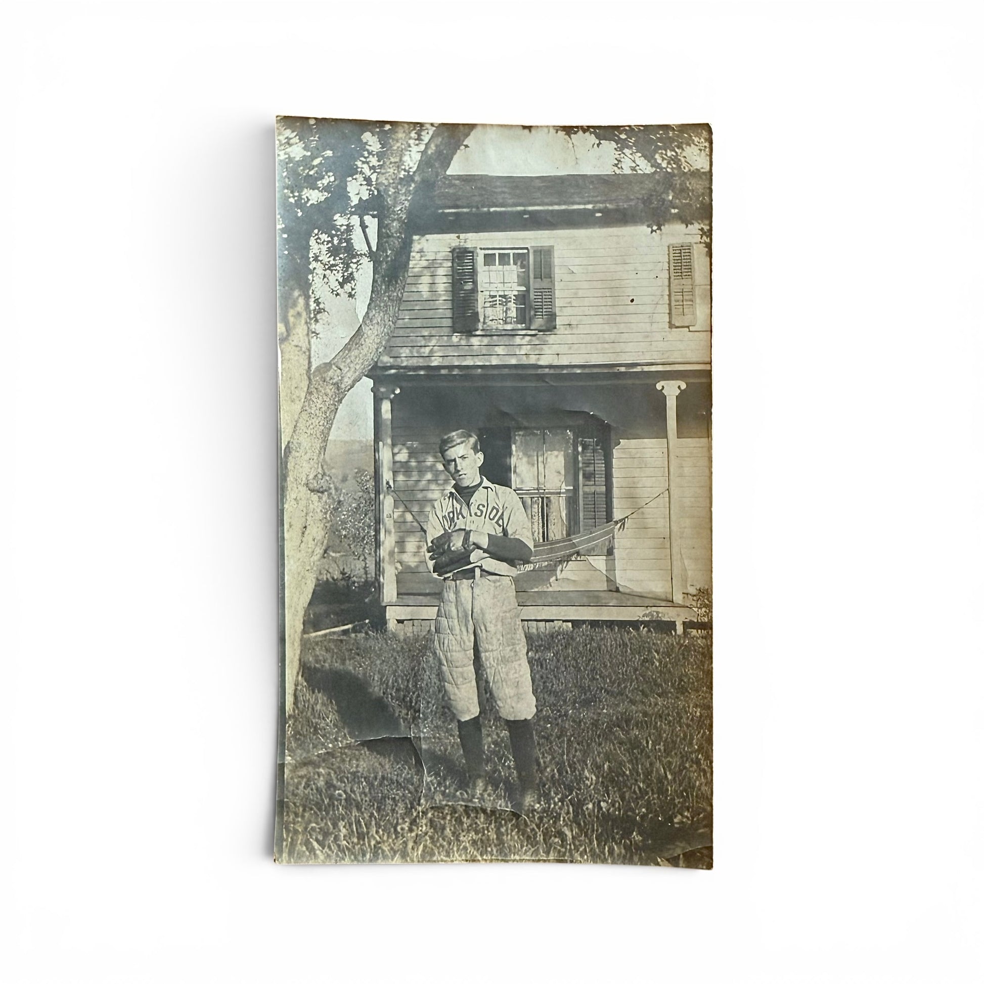 A Serious Baseball Player - Snapshot Vintage photo of a boy in a baseball uniform in front of a house