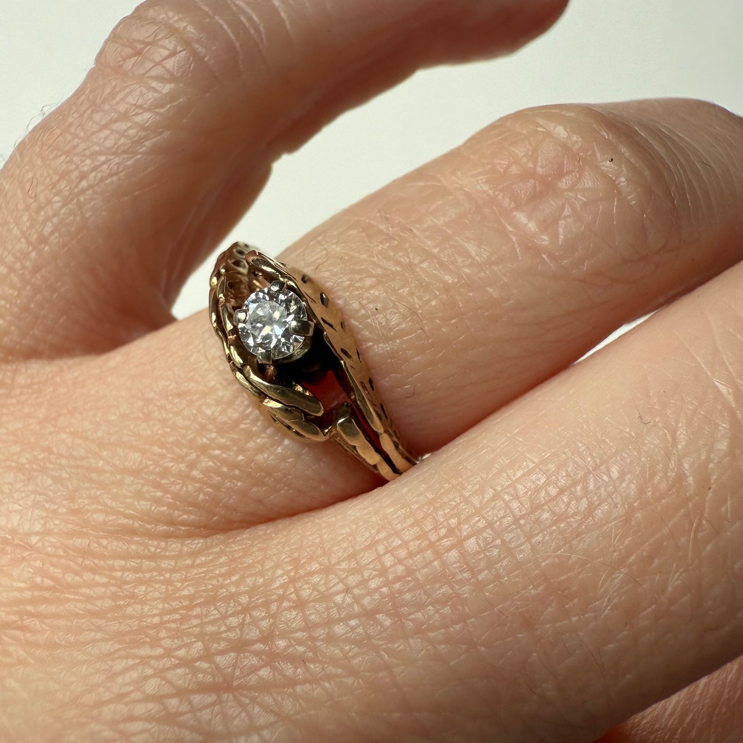 close- up Antique European Cut .25ct Diamond Bypass 14k Ring on hand