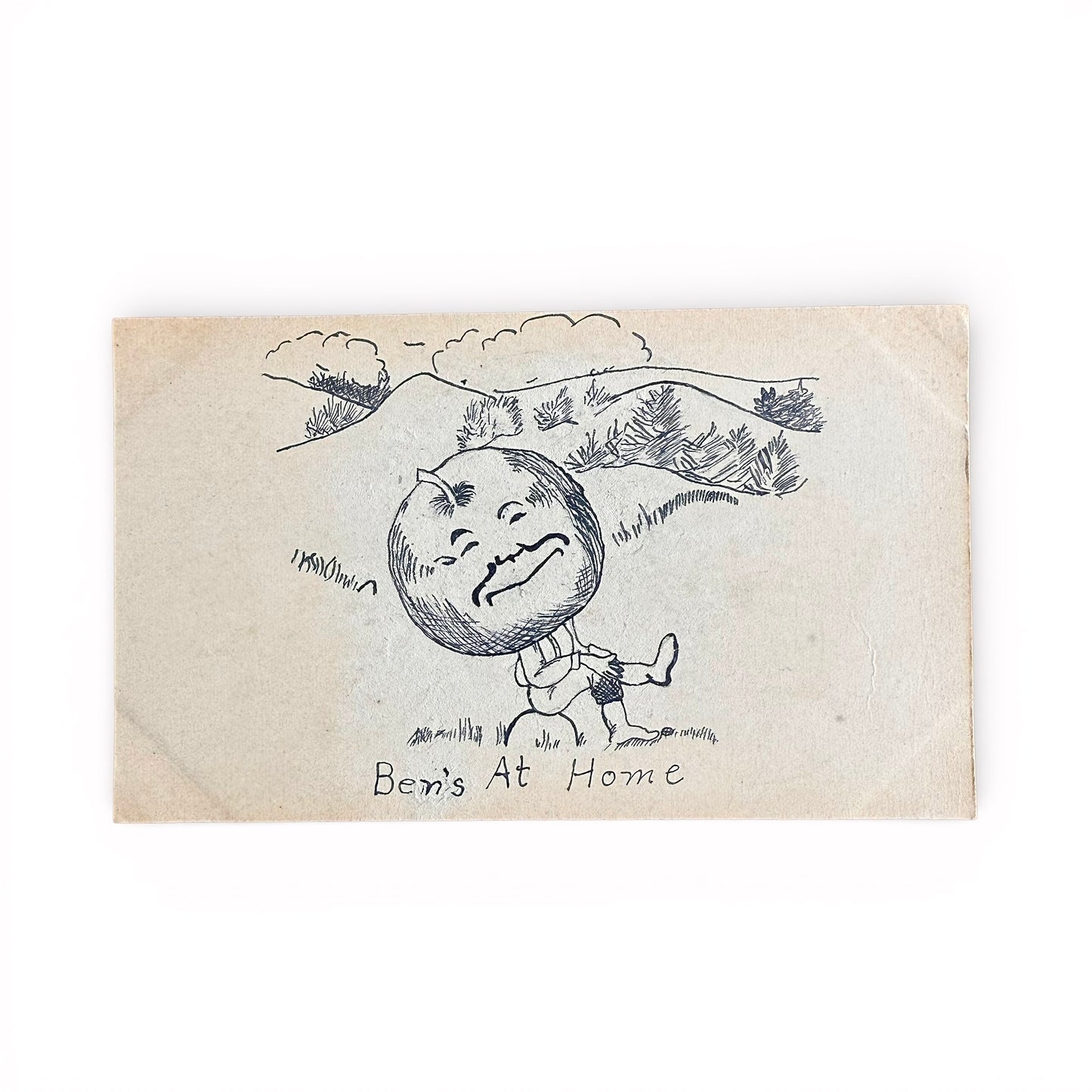 "Ben's At Home" - Pen and Ink 1907 Postcard Art Vintage illustration of an apple with a face and a person, labeled 'Ben's At Home', on a textured paper background.