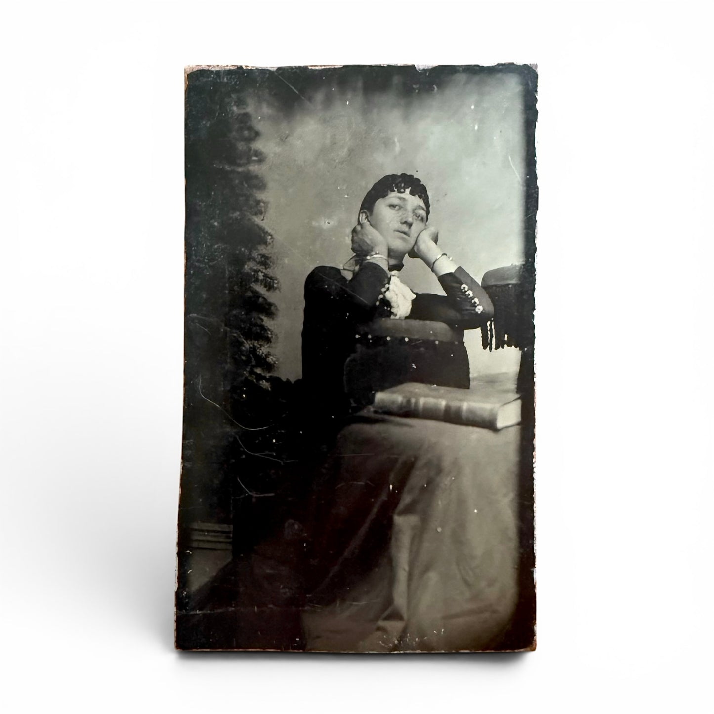Daydreamer - Tintype Vintage photograph of a woman sitting with a book on a white background