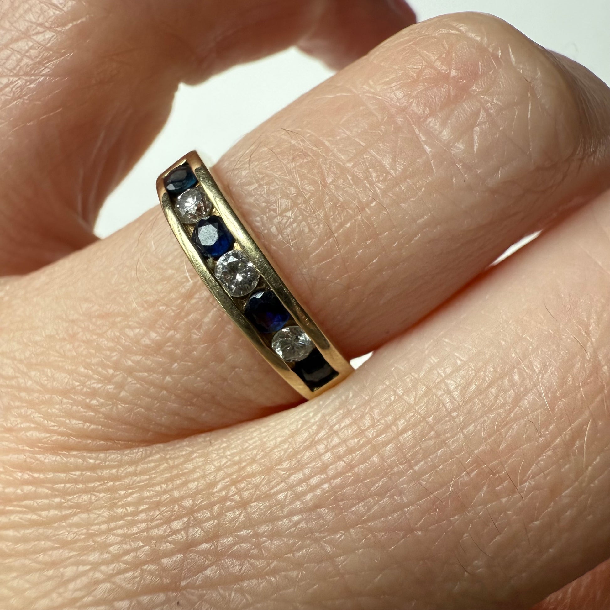 close-up of Diamond and Sapphire 14k Half Eternity Ring on hand