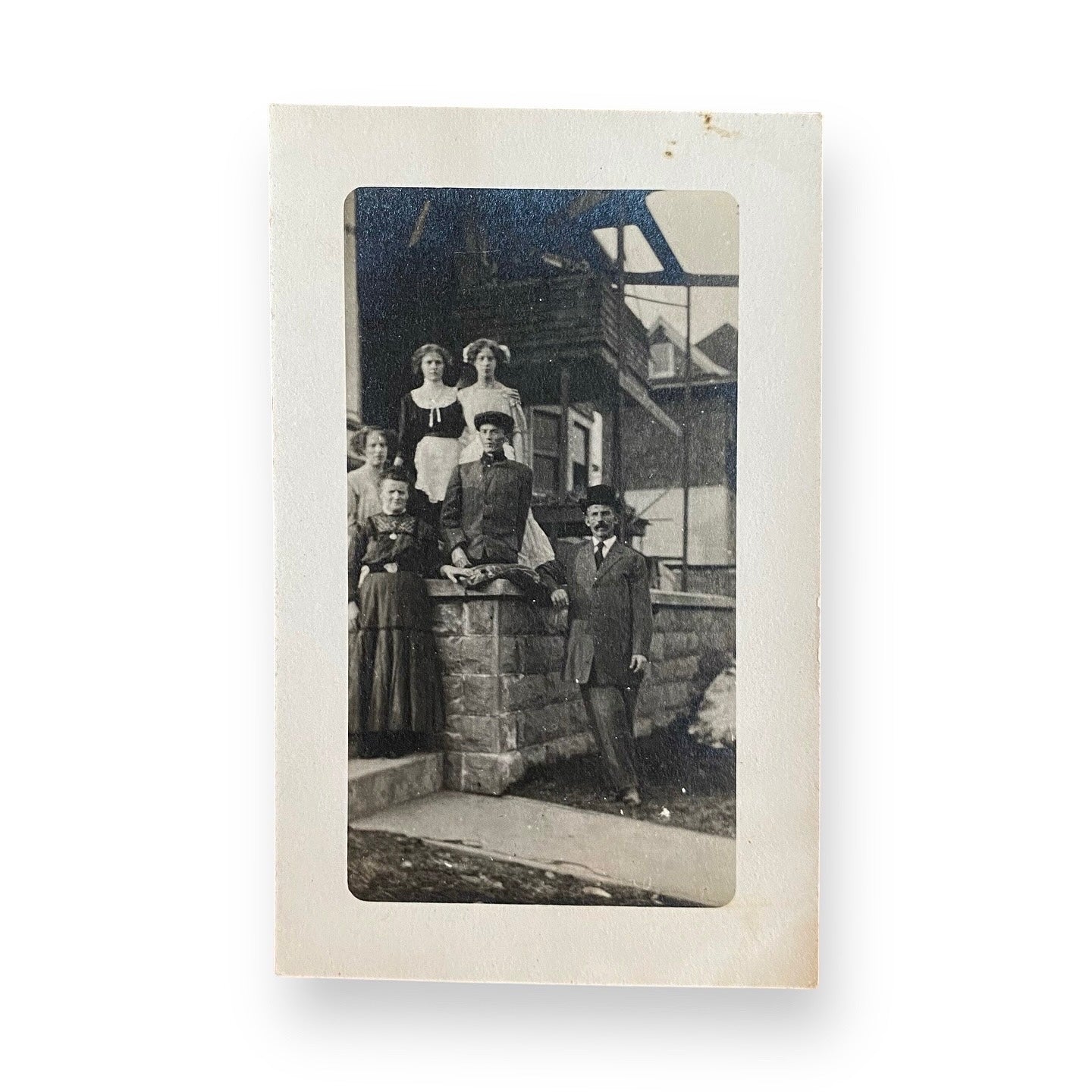 Family Portrait On Front Porch with amputee son sitting on stone wall - RPPC