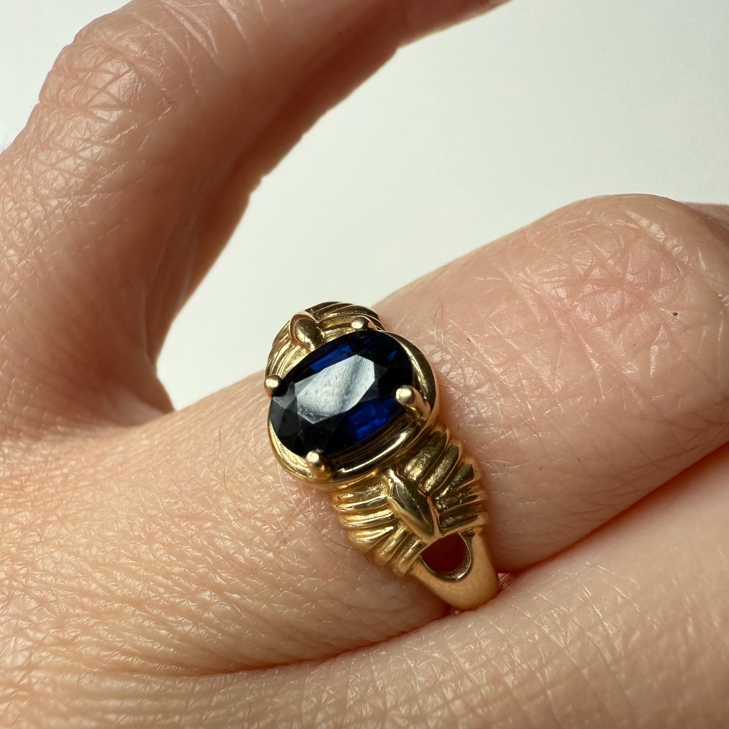 close-up of French Art Deco 14k Yellow Gold Sapphire Ring on hand