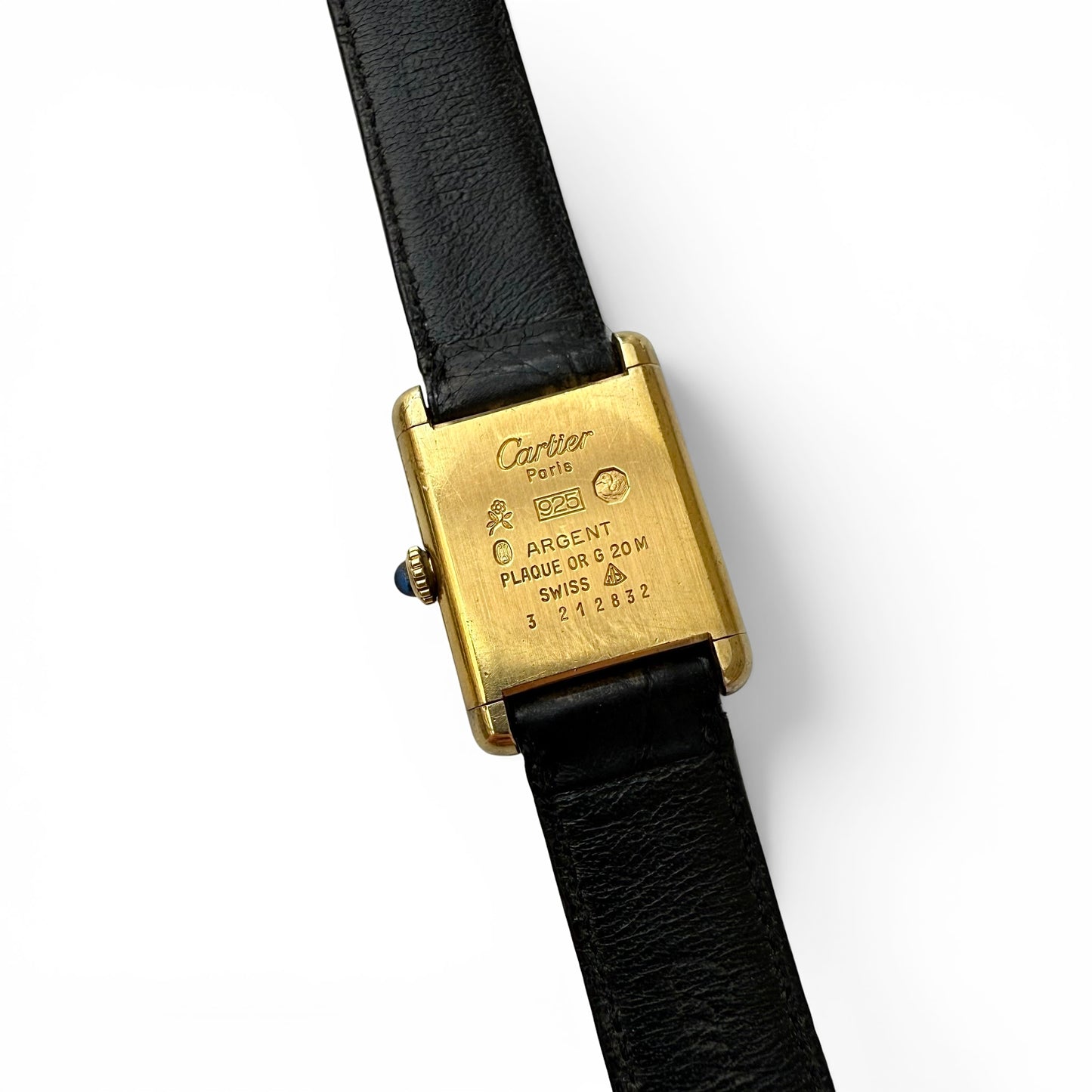 Late 1970s Must De Cartier Manual Wind Tank Watch Cartier watch with gold case and black leather strap on a white background