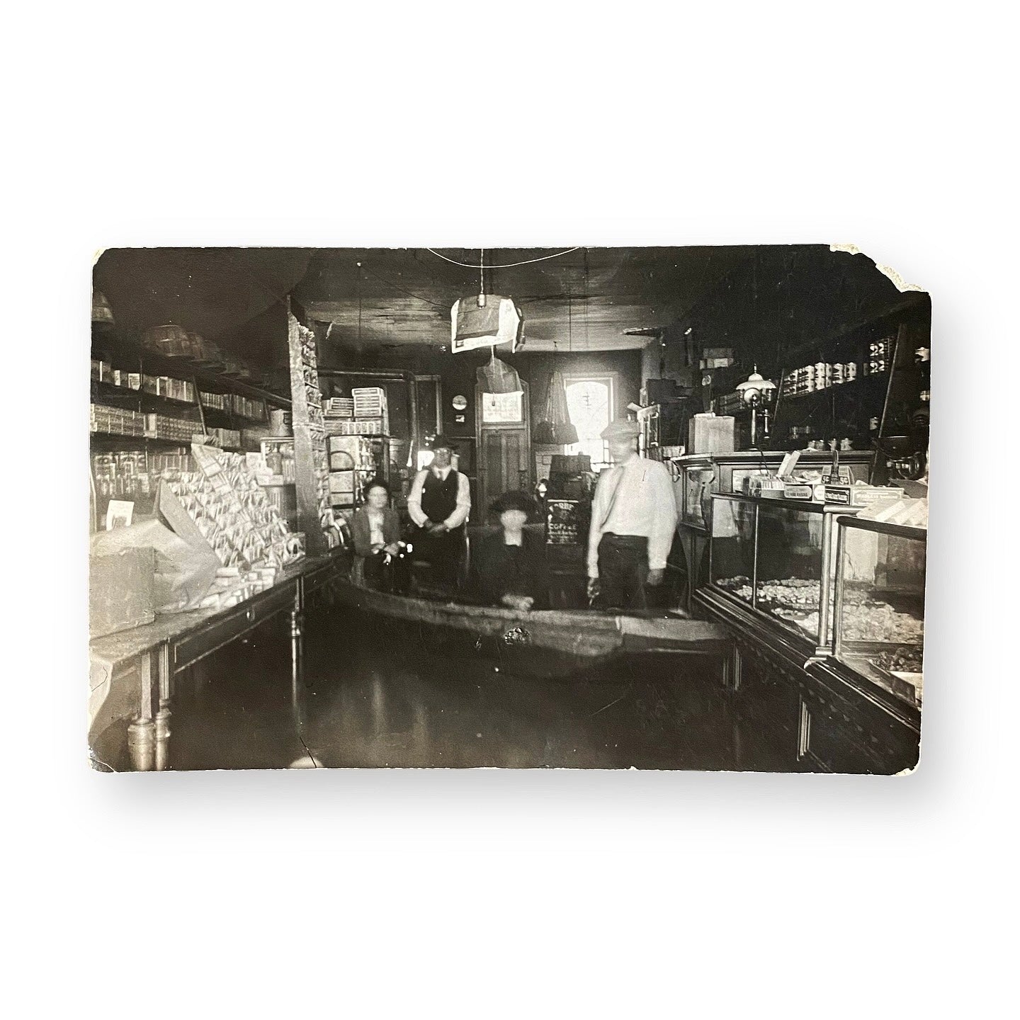 On A Boat In A Flooded Shop - RPPC Vintage black and white photo of a store interior with people inside.
