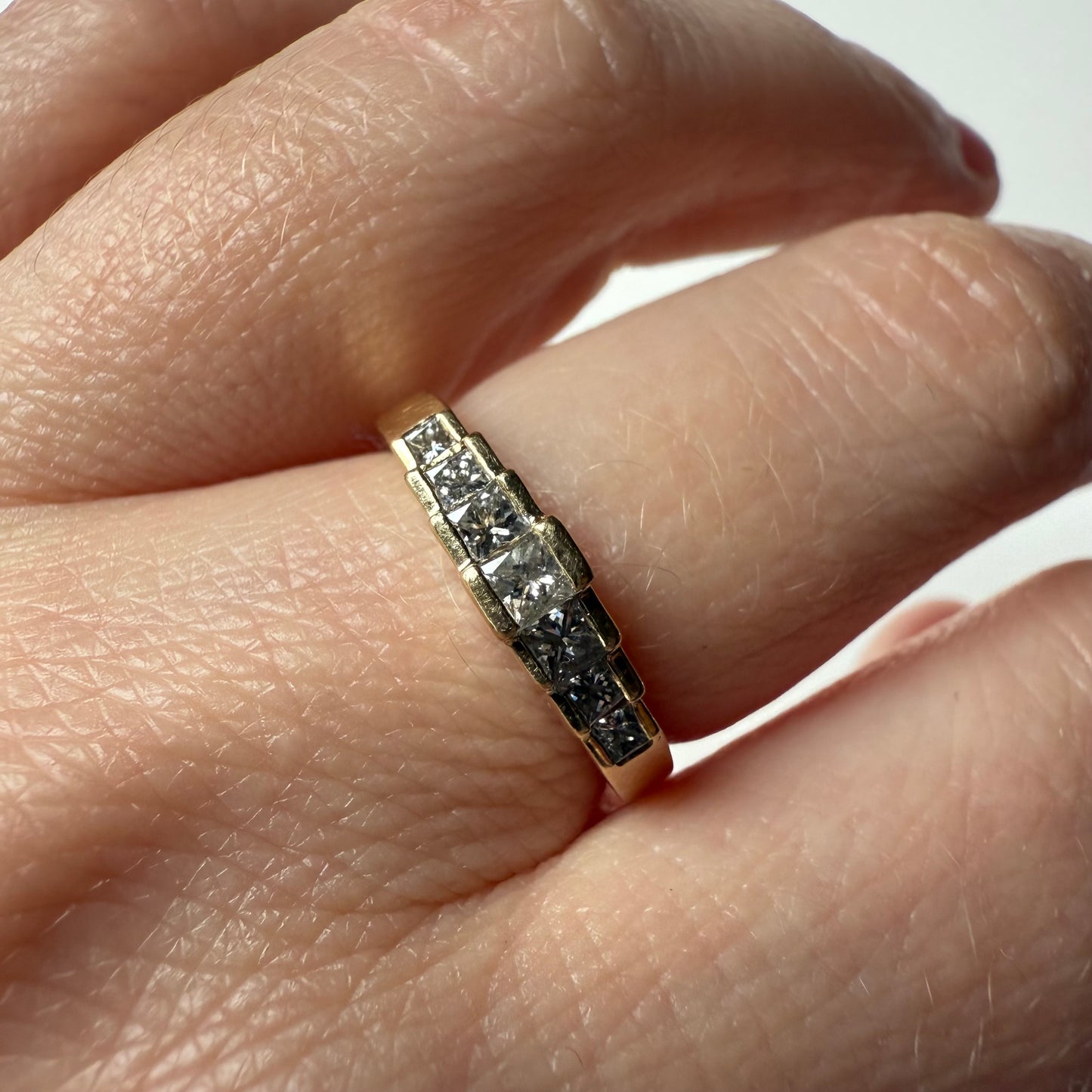close-up of Pyramid Rise 14k Yellow Gold Princess Cut .54ctw Diamond Ring on hand