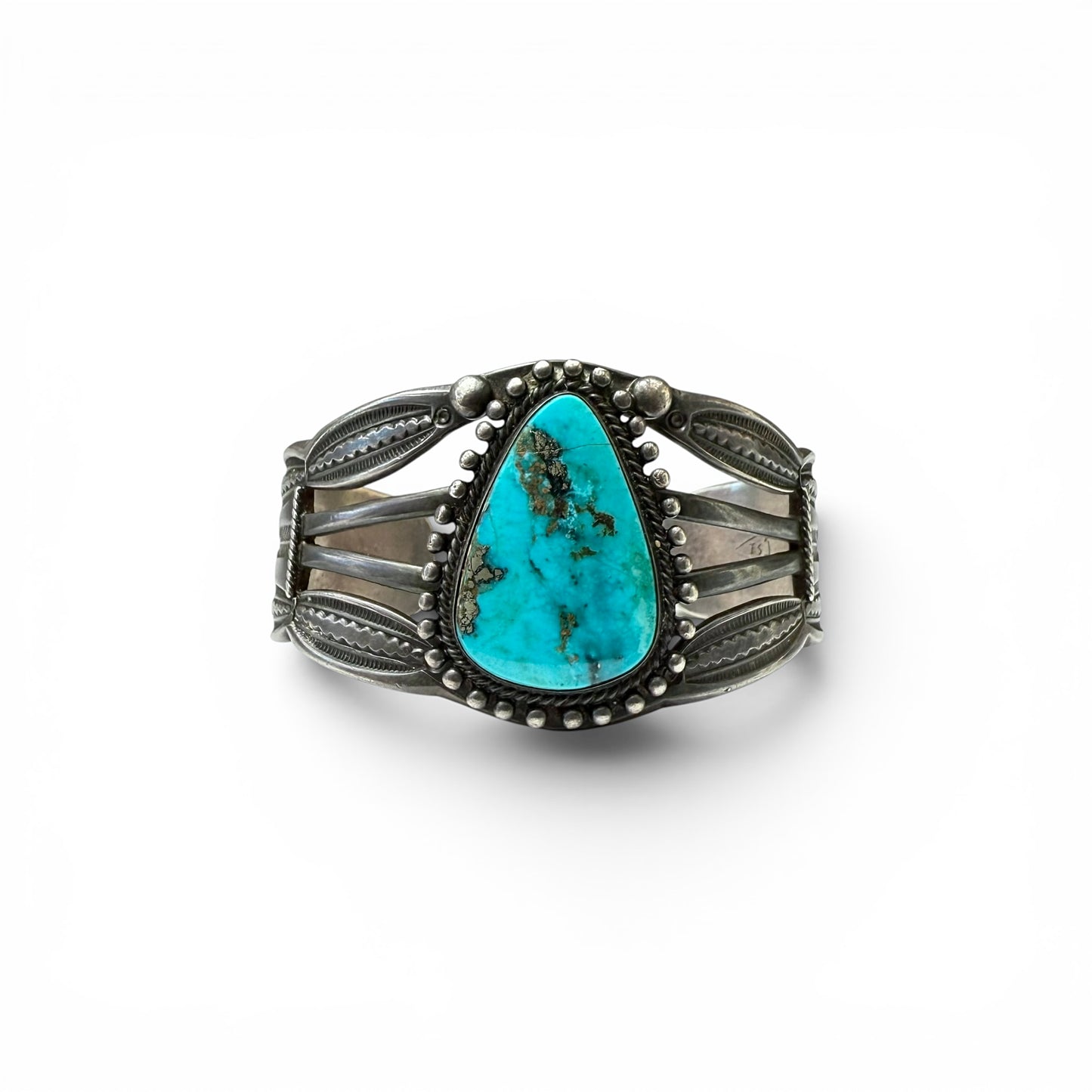 Vintage Sterling Silver & Turquoise Diné (Navajo) Bracelet Turquoise stone bracelet with silver detailing on a white background