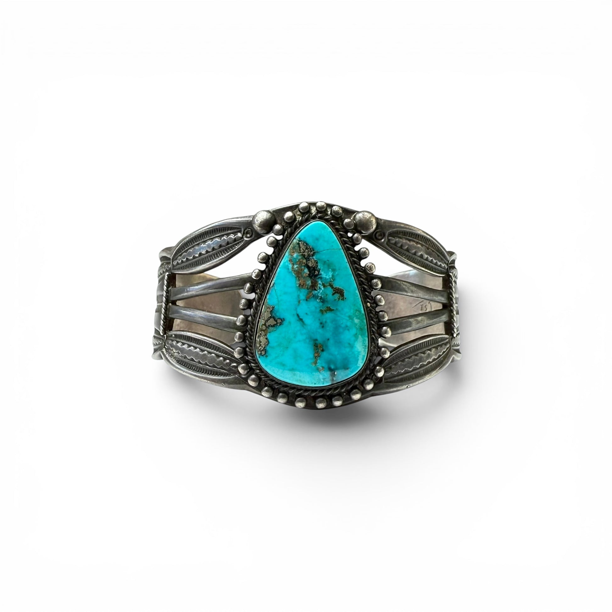 Vintage Sterling Silver & Turquoise Diné (Navajo) Bracelet Turquoise stone bracelet with silver detailing on a white background