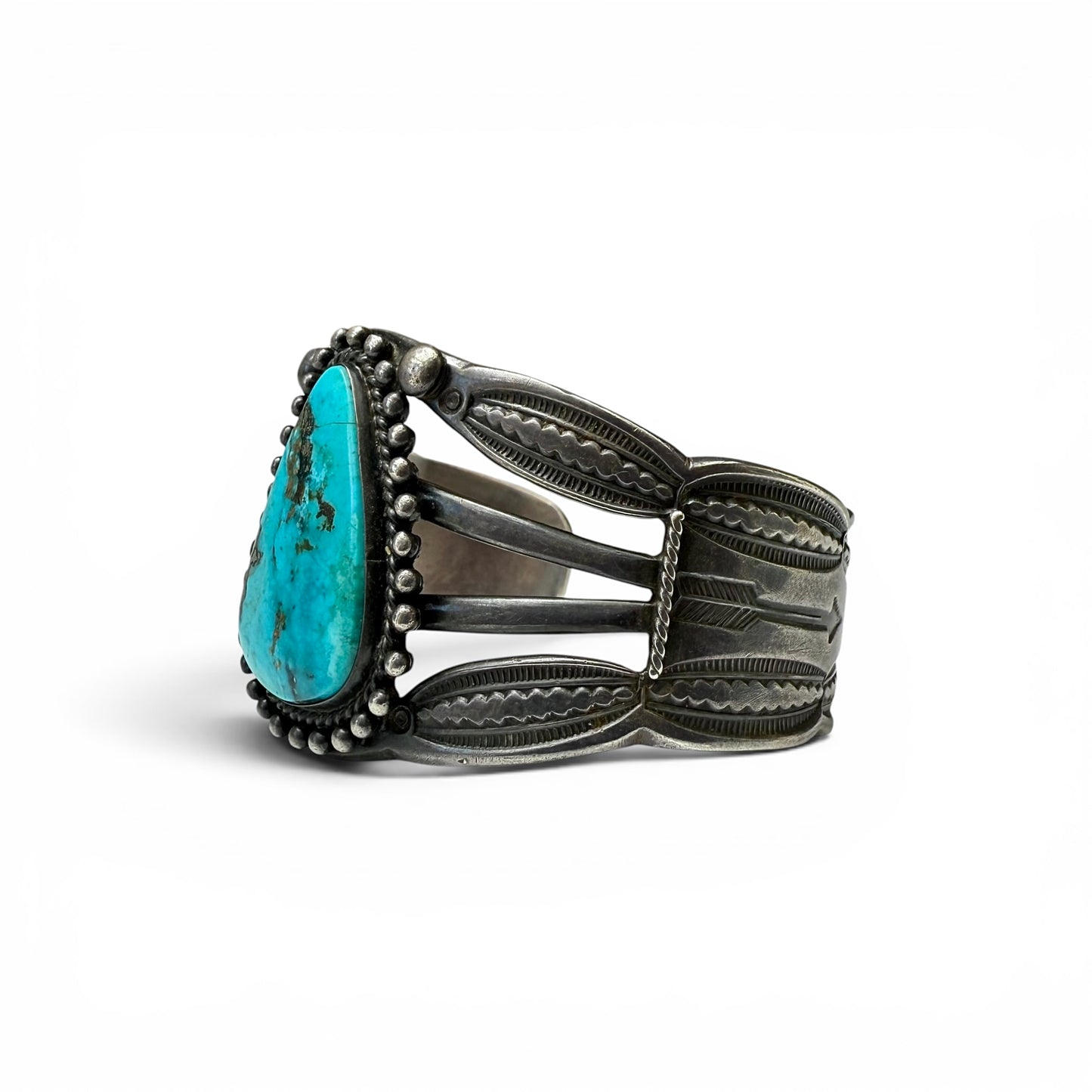 Vintage Sterling Silver & Turquoise Diné (Navajo) BraceletSilver bracelet with a large turquoise stone on a white background