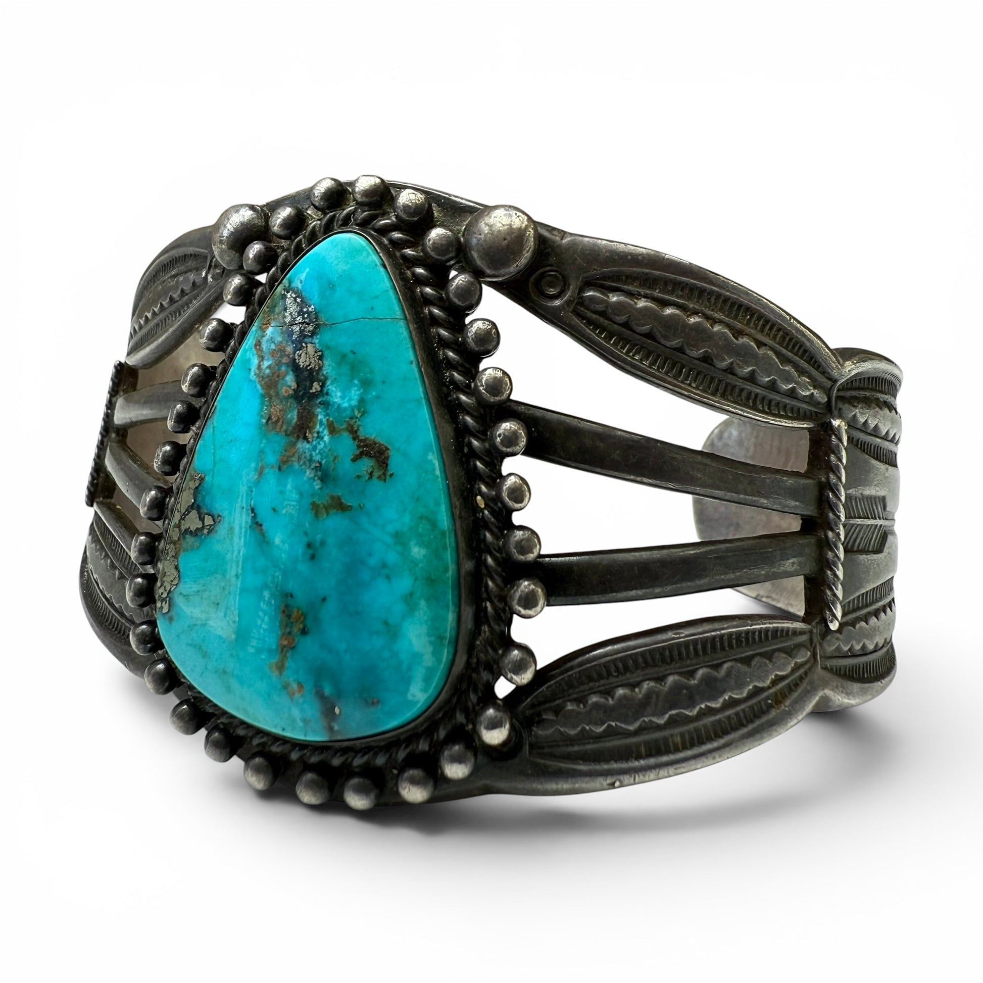 Vintage Sterling Silver & Turquoise Diné (Navajo) Bracelet Turquoise stone bracelet with silver band on a white background