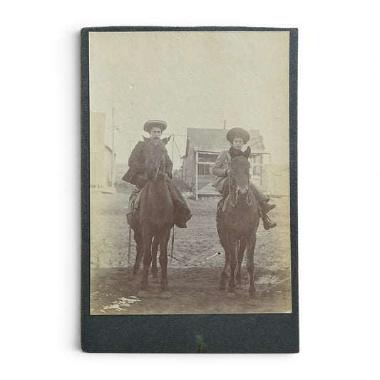 Women Of The Old West- Cabinet Card Vintage photograph of two women on horseback with a building in the background